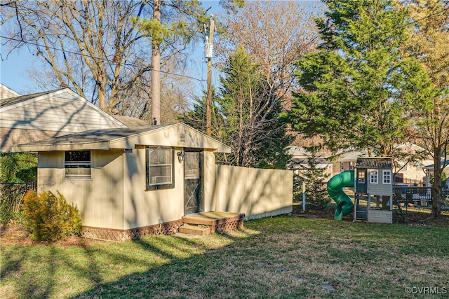 view of outbuilding with a lawn and a playground