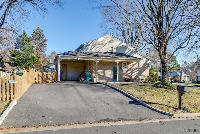 view of front of property with a carport and a front yard