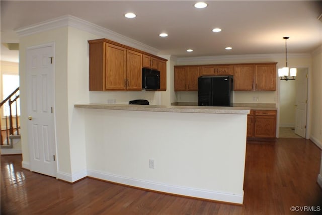 kitchen featuring dark hardwood / wood-style floors, decorative light fixtures, kitchen peninsula, and black appliances