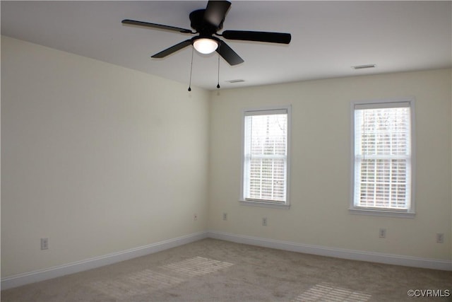 carpeted spare room with ceiling fan