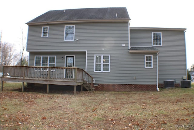 rear view of house with a deck and a lawn