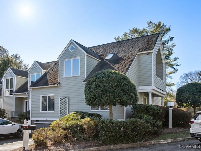 view of front facade featuring roof with shingles