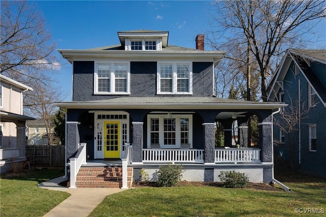 view of front of home with covered porch and a front lawn