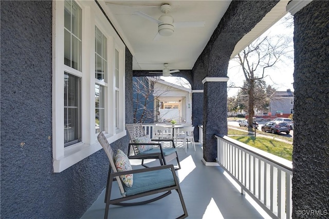 balcony with ceiling fan and covered porch