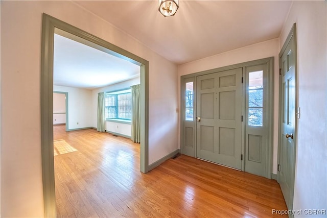 entryway featuring light wood finished floors and baseboards