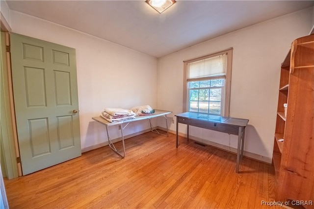 office area with light wood-style flooring and baseboards