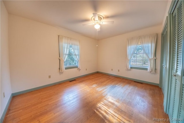 unfurnished bedroom featuring light wood finished floors, visible vents, and baseboards