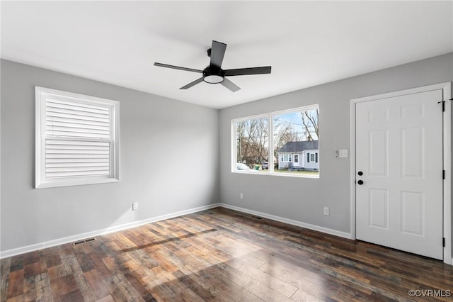 spare room featuring ceiling fan and dark hardwood / wood-style flooring