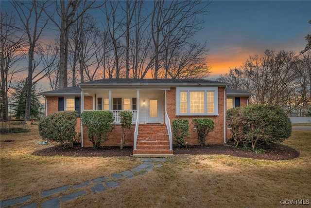 view of front of property featuring a lawn and covered porch