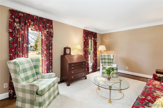 living area with baseboards, wood finished floors, and crown molding