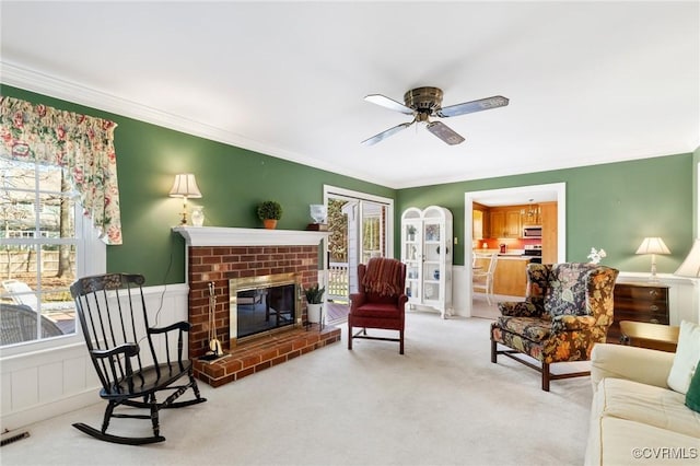 living room featuring carpet, ornamental molding, and plenty of natural light