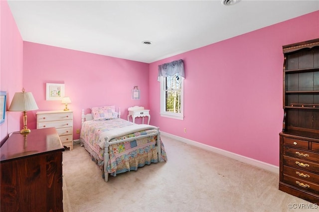 carpeted bedroom featuring visible vents and baseboards