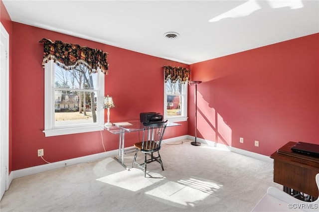 office featuring carpet floors, visible vents, and baseboards