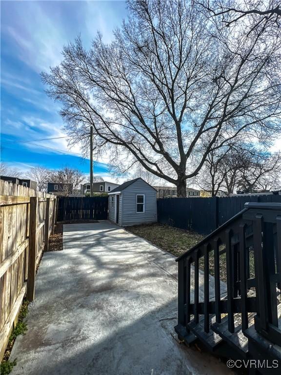 view of yard with a storage unit and a patio