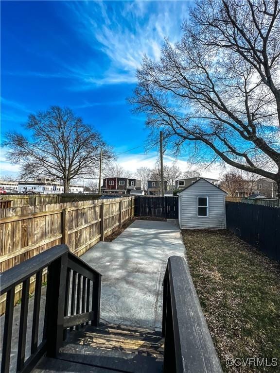 wooden deck featuring a storage unit