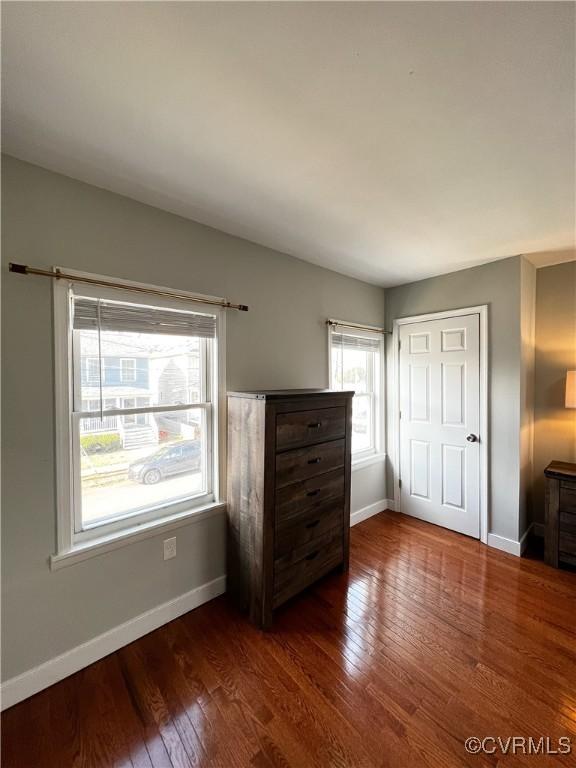 unfurnished bedroom with dark hardwood / wood-style floors