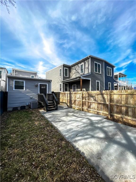 back of property with a patio and cooling unit