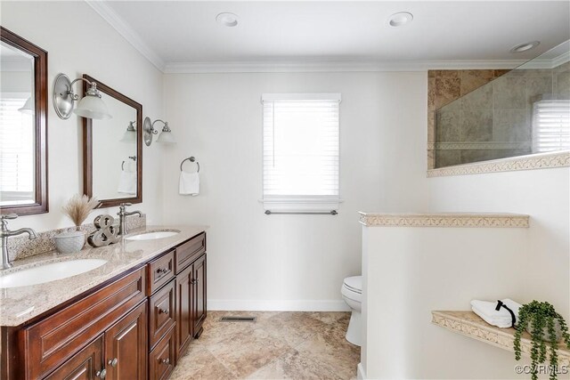 bathroom with crown molding, a sink, and toilet