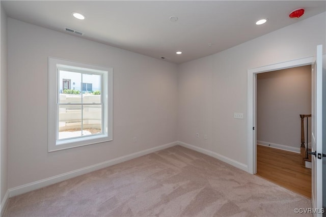 unfurnished room with light carpet