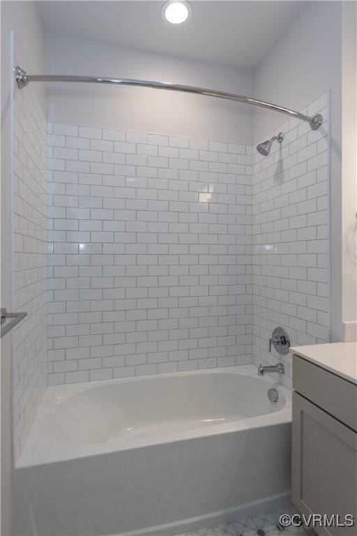 bathroom with vanity and tiled shower / bath combo