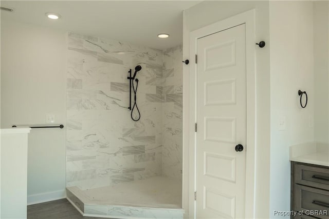 bathroom with vanity and tiled shower