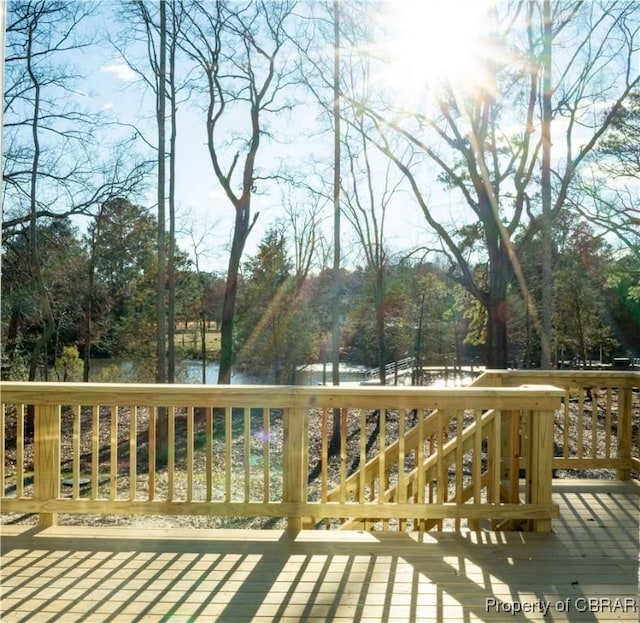 wooden deck featuring a water view