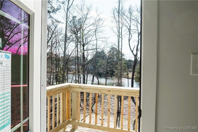 wooden terrace featuring a water view