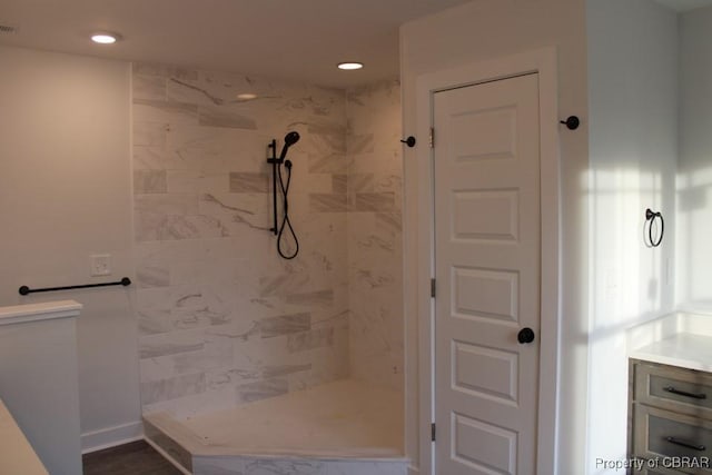 bathroom featuring vanity and a tile shower