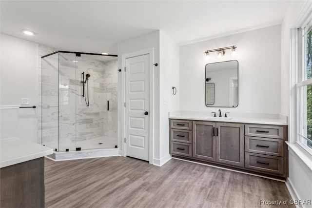 8280 Mobjack Ln, Hayes, VA 23072 - bathroom featuring wood finished floors, a wealth of natural light, a stall shower, and vanity