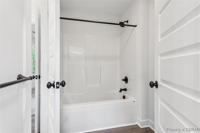 8280 Mobjack Ln, Hayes, VA 23072 - full bath with shower / bathing tub combination, wood finished floors, and baseboards