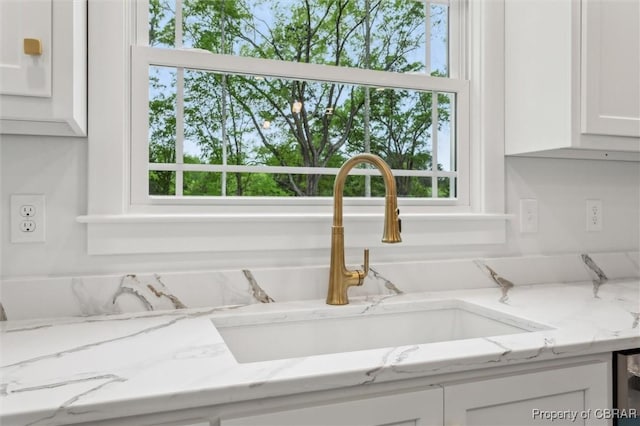 8280 Mobjack Ln, Hayes, VA 23072 - details featuring white cabinetry, light stone countertops, and a sink