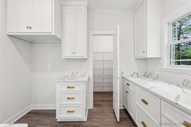 8280 Mobjack Ln, Hayes, VA 23072 - kitchen with dark wood-style floors, light stone counters, and white cabinetry
