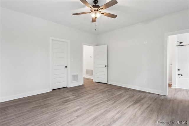 8280 Mobjack Ln, Hayes, VA 23072 - spare room with visible vents, ceiling fan, wood finished floors, and baseboards