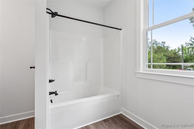 8280 Mobjack Ln, Hayes, VA 23072 - full bath featuring wood finished floors, shower / bath combination, and baseboards