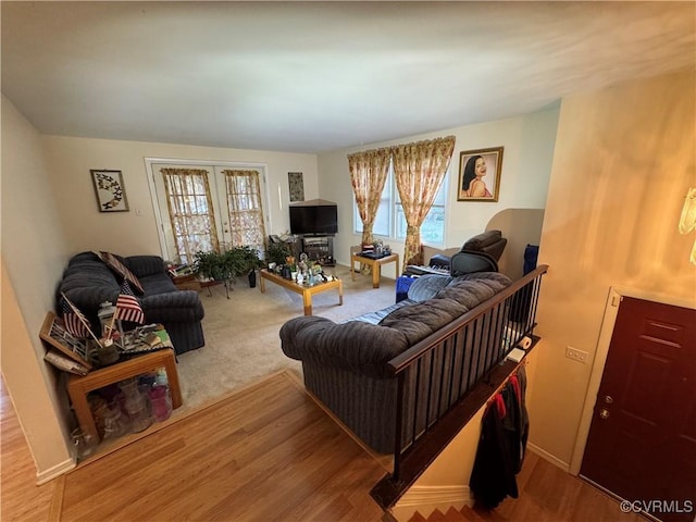 living room with baseboards, wood finished floors, and french doors