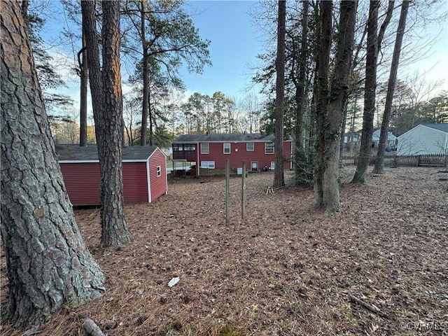 view of yard featuring an outbuilding and a storage shed