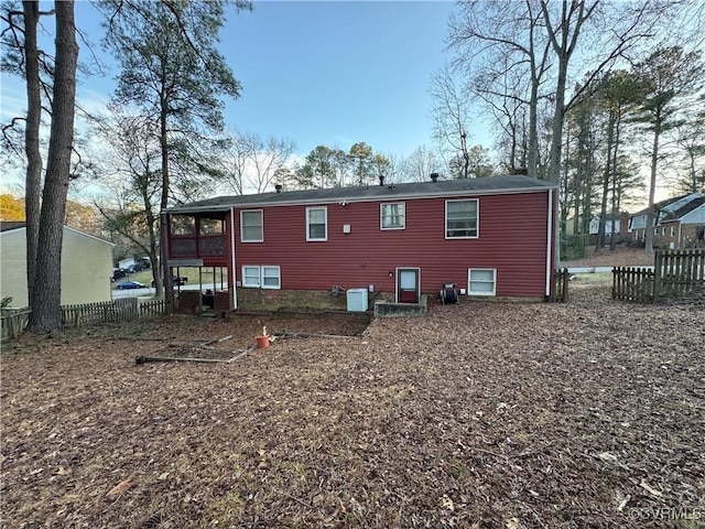 back of property with central AC and fence