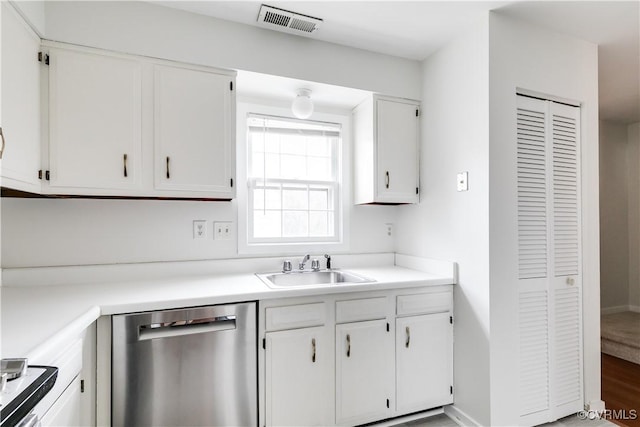 kitchen with dishwasher, sink, and white cabinets