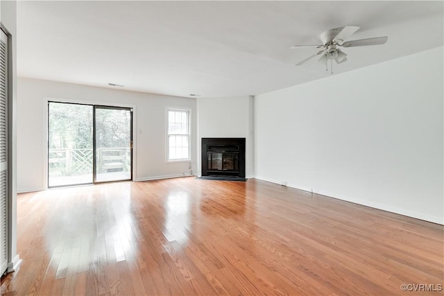 unfurnished living room with ceiling fan and light wood-type flooring