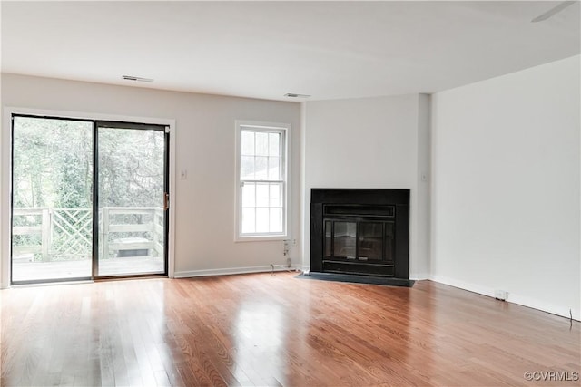 unfurnished living room with wood-type flooring