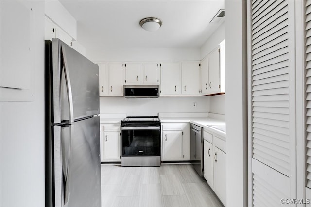 kitchen featuring white cabinetry, appliances with stainless steel finishes, and sink