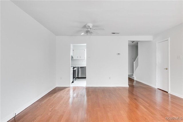 empty room with ceiling fan and light wood-type flooring