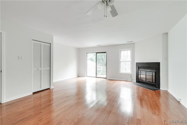 unfurnished living room featuring light hardwood / wood-style flooring and ceiling fan