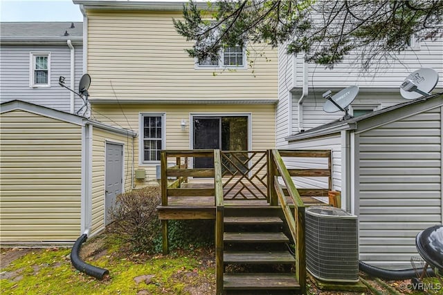 rear view of property featuring central AC and a deck