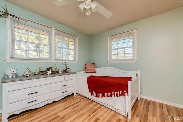 bedroom with ceiling fan and light hardwood / wood-style flooring