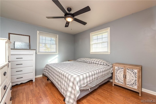 bedroom with ceiling fan and light hardwood / wood-style floors