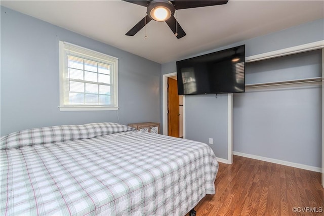 bedroom featuring hardwood / wood-style flooring, a closet, and ceiling fan