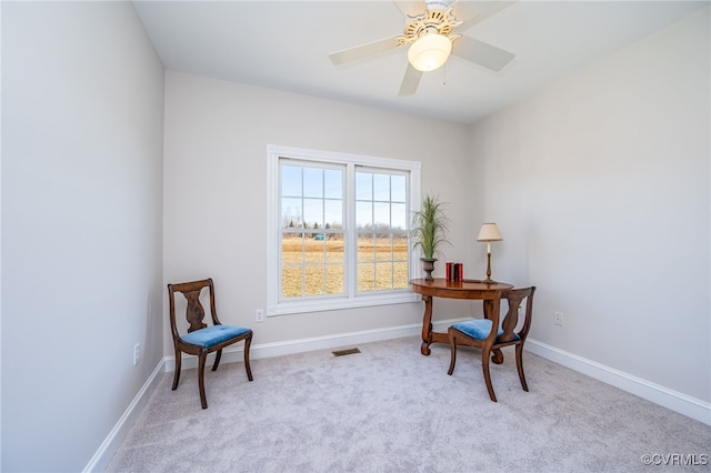 home office with light carpet, ceiling fan, visible vents, and baseboards