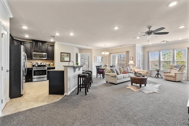 living room with light carpet, ceiling fan with notable chandelier, and ornamental molding