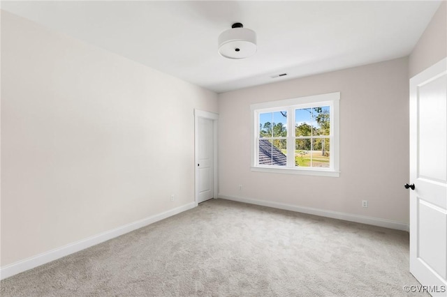 spare room with light colored carpet